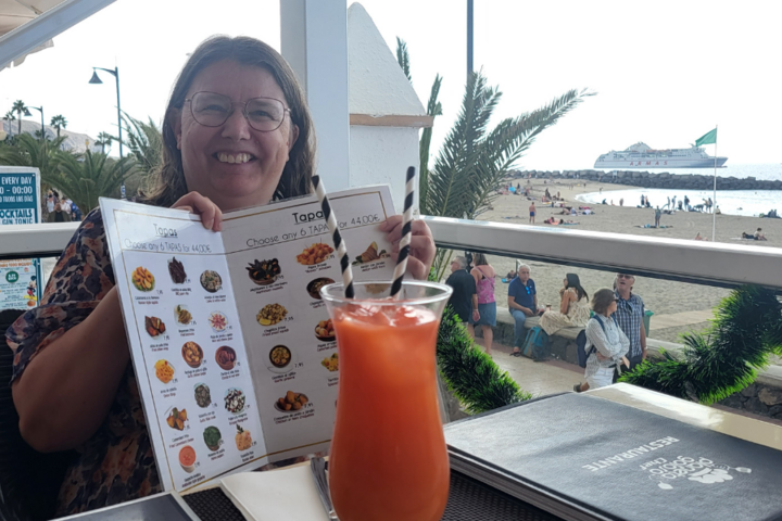 Buitenhof Reizen - Kerst op Tenerife - begeleide groepsreizen met een verstandelijke beperking - reiziger met kaart en cocktail