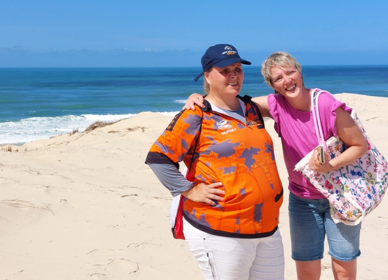 Buitenhof Reizen voor mensen met een verstandelijke beperking - Jongeren - Atlantische kust - reizigers op het strand met blauwe zee op de achtergrond